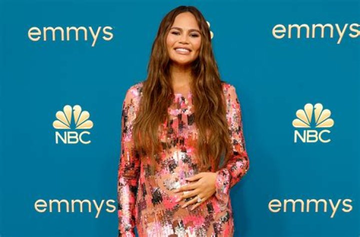 Chrissy Teigen Shows Off Her Hooters Uniform
